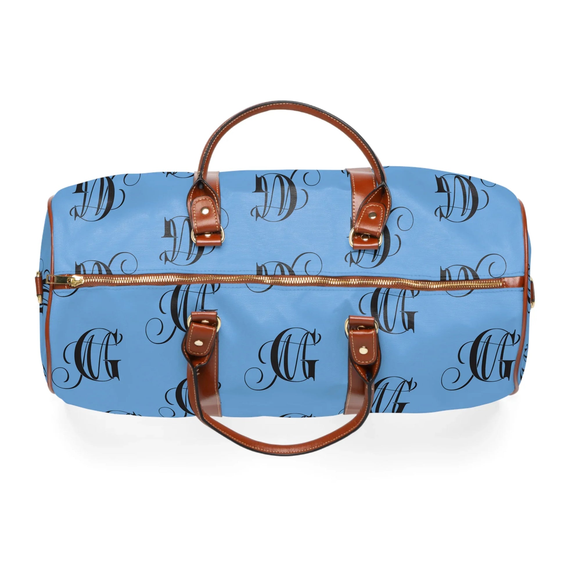 Blue duffel bag with brown leather handles and black monogram pattern on white background