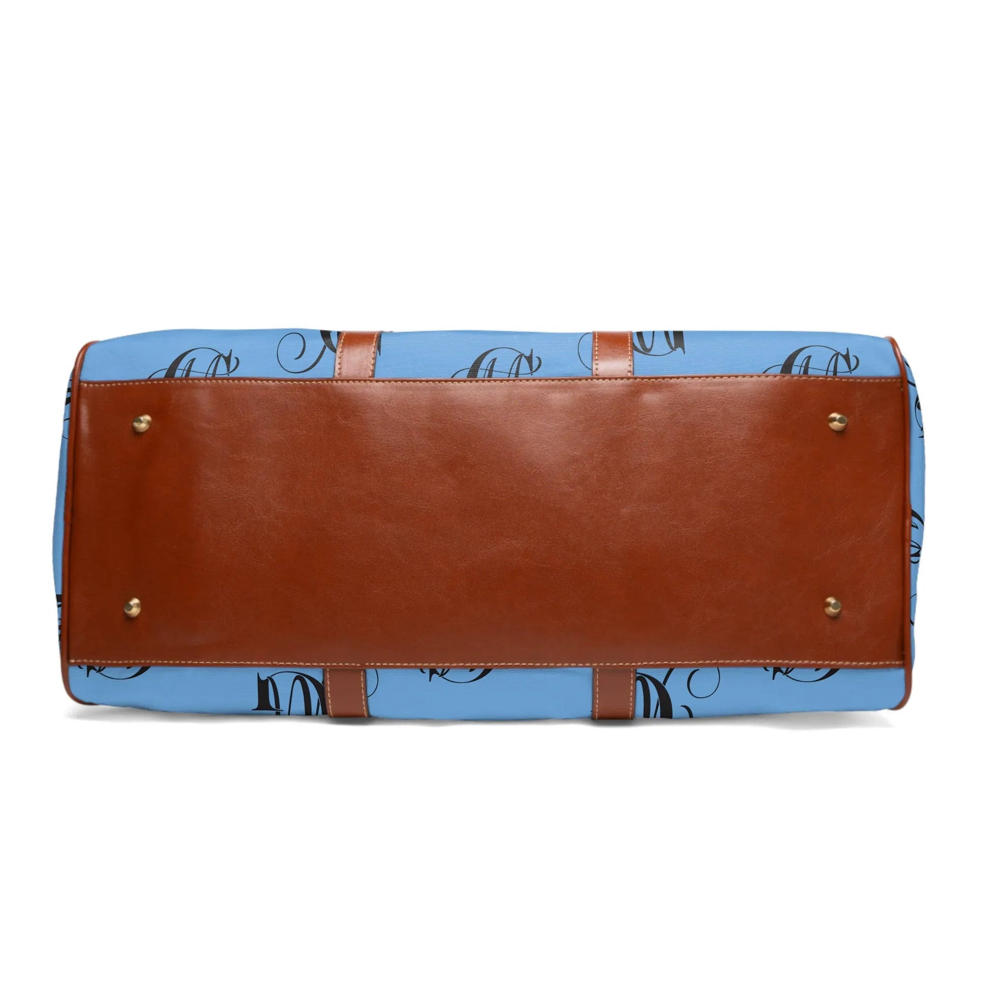 Bottom view of blue duffel bag with brown leather base and gold metal feet on white background