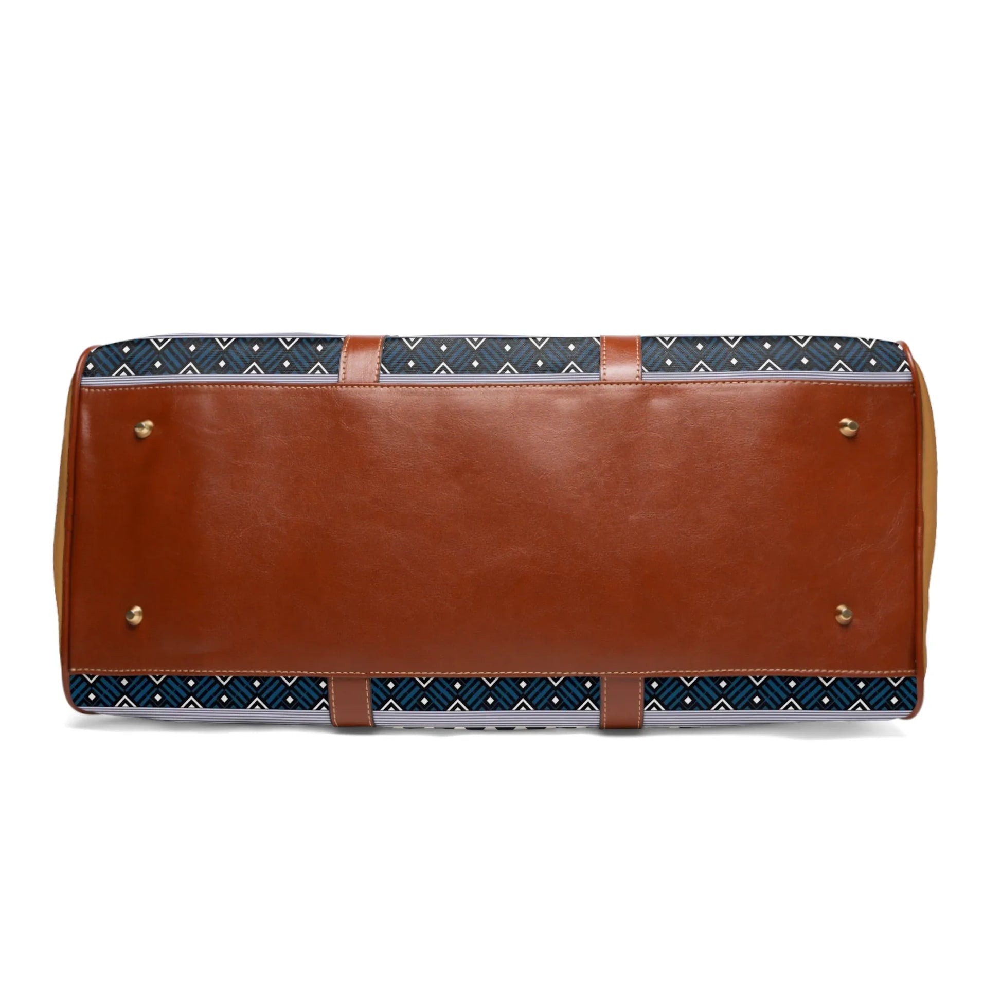 Bottom view of a patterned fabric and brown leather handbag with metal feet on white background
